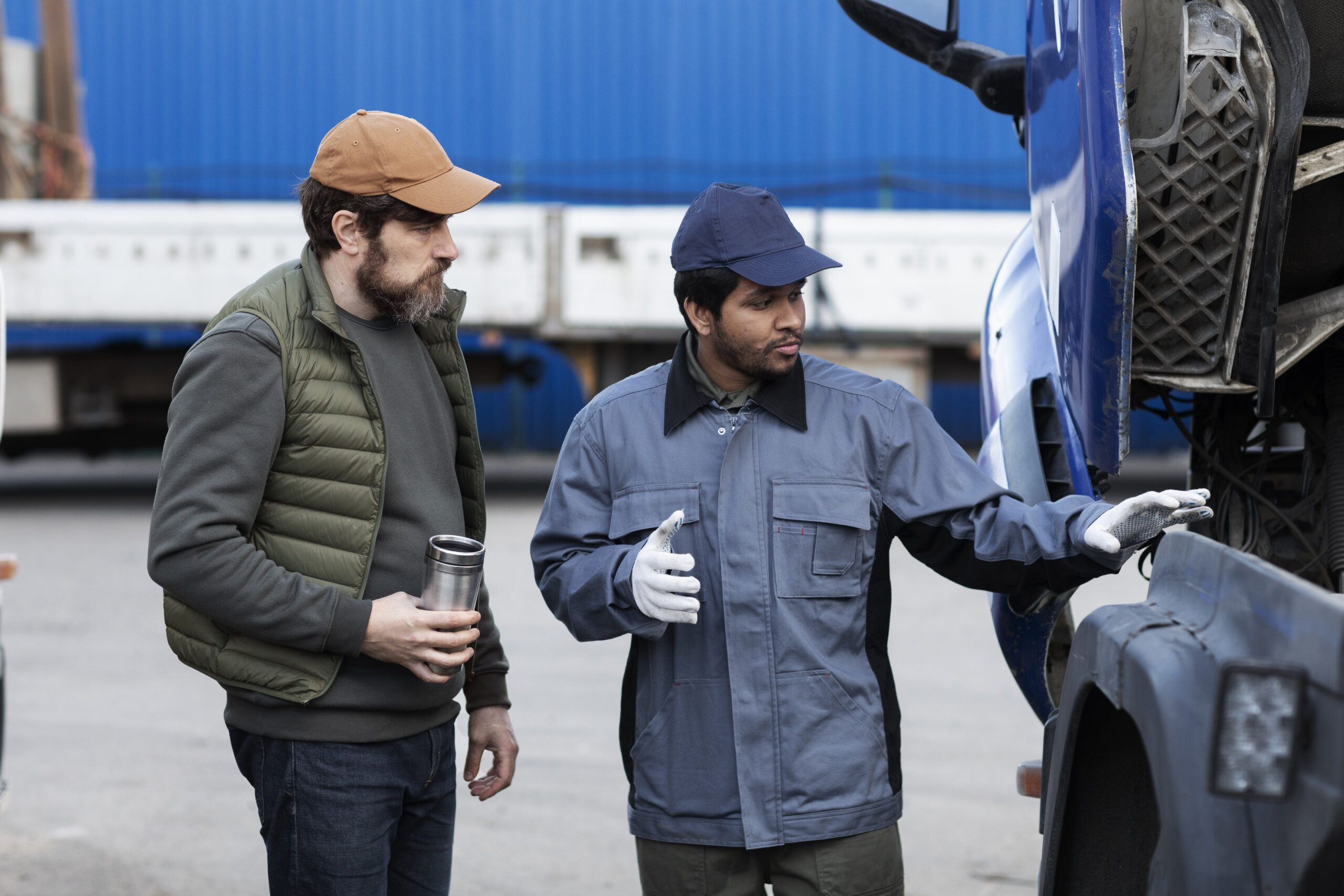 side view men looking inside truck